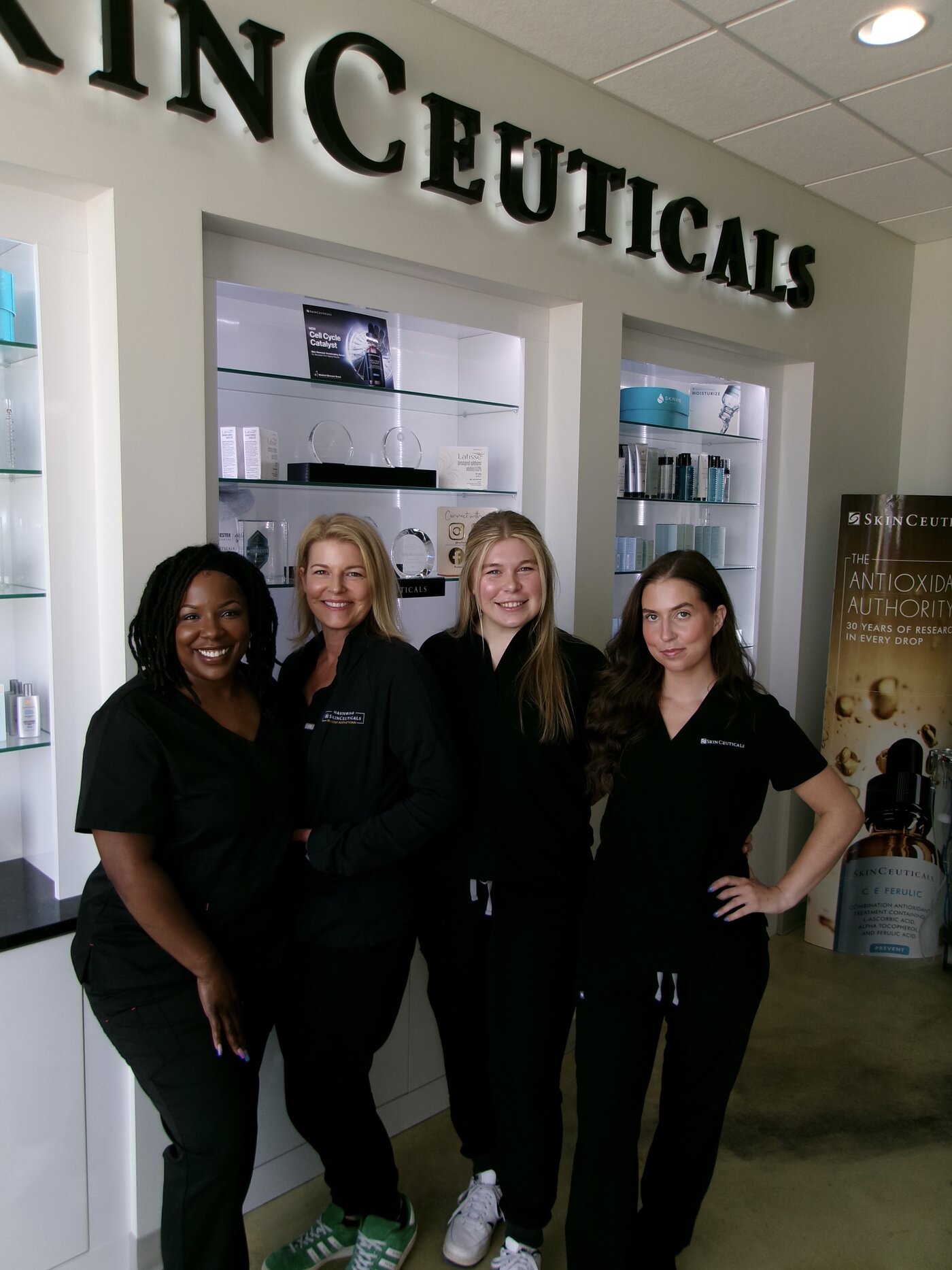 The Rochester Laser Center team in front of the SkinCeuticals display